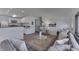 Inviting living area with gray sofa, glass coffee table, and a view of the modern kitchen at 91 Crestview Dr, Greenwood, IN 46143