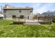 Spacious backyard featuring a wooden deck and well-maintained lawn for outdoor enjoyment at 9162 Hadway Dr, Indianapolis, IN 46256