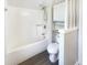 All-white bathroom featuring a bathtub and shower with a window and stylish storage at 9162 Hadway Dr, Indianapolis, IN 46256