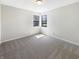 A bright bedroom with neutral carpet, and large windows providing natural light at 9162 Hadway Dr, Indianapolis, IN 46256