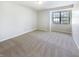 Simple bedroom with carpet, a large window with natural light, and white walls at 9162 Hadway Dr, Indianapolis, IN 46256