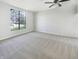 A bright bedroom features neutral carpet, a ceiling fan, and a large window showcasing the outside view at 9162 Hadway Dr, Indianapolis, IN 46256