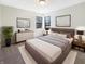 Cozy bedroom with a large bed, white walls, and dark framed windows with natural light at 9162 Hadway Dr, Indianapolis, IN 46256