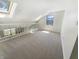 Bright bonus room with skylight and natural light, featuring neutral carpet and white railing at 9162 Hadway Dr, Indianapolis, IN 46256