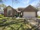 Charming two-story brick home with a well-maintained front yard and attached two car garage at 9162 Hadway Dr, Indianapolis, IN 46256