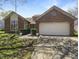 Well maintained two-story brick home with an attached two car garage and blue sky backdrop at 9162 Hadway Dr, Indianapolis, IN 46256