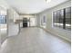 An open concept kitchen boasting white cabinets, modern appliances, tiled flooring, and natural light at 9162 Hadway Dr, Indianapolis, IN 46256