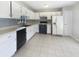 A bright kitchen featuring white cabinets, modern appliances, and tiled flooring for easy maintenance at 9162 Hadway Dr, Indianapolis, IN 46256