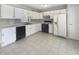 Functional kitchen with white cabinets, neutral countertop, and black appliances at 9162 Hadway Dr, Indianapolis, IN 46256