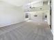 Spacious living room with neutral carpet, an open floor plan, and natural light from multiple windows at 9162 Hadway Dr, Indianapolis, IN 46256