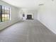 A spacious living room with a fireplace, carpet flooring, and an abundance of natural light from large windows at 9162 Hadway Dr, Indianapolis, IN 46256