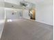 Bright living room with neutral carpet, open floor plan, and natural light from large windows at 9162 Hadway Dr, Indianapolis, IN 46256