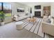 Bright living room featuring a fireplace, plush seating, and large windows with a view to the backyard at 9162 Hadway Dr, Indianapolis, IN 46256