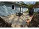 Wooden backyard deck with table and chairs leading to a fenced backyard at 10360 Wilson Rd, Brownsburg, IN 46112