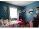 Bright bedroom with colorful decor, a cozy bed, and decorative wall art at 10360 Wilson Rd, Brownsburg, IN 46112