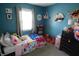 Charming bedroom featuring colorful bedding and decor accents against a blue wall backdrop at 10360 Wilson Rd, Brownsburg, IN 46112