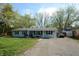 Charming single story home with light blue siding, black shutters and a spacious driveway at 10360 Wilson Rd, Brownsburg, IN 46112