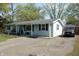 Charming single story home with light blue siding, black shutters and a spacious driveway at 10360 Wilson Rd, Brownsburg, IN 46112