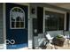 Inviting front porch with a 'Welcome' sign, seating, and decorative plants at 10360 Wilson Rd, Brownsburg, IN 46112