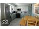 Modern kitchen with stainless steel appliances, granite countertops, and a dining table at 10360 Wilson Rd, Brownsburg, IN 46112