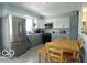 Updated kitchen with stainless steel appliances and an adjacent dining area at 10360 Wilson Rd, Brownsburg, IN 46112
