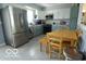 Well-equipped kitchen with stainless steel appliances, two-tone cabinets, and a dining table at 10360 Wilson Rd, Brownsburg, IN 46112