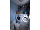 Functional laundry room with modern washer and dryer units, plus storage shelves for organization at 10360 Wilson Rd, Brownsburg, IN 46112