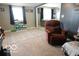 Cozy living room with neutral carpeting, a recliner, and ample natural light at 10360 Wilson Rd, Brownsburg, IN 46112