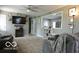 Open-concept living room with modern furniture and view to kitchen, great natural light at 10360 Wilson Rd, Brownsburg, IN 46112