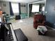 Cozy living room with a piano, comfortable seating, and a patterned rug, providing an inviting atmosphere at 10360 Wilson Rd, Brownsburg, IN 46112