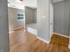 A bathroom featuring hard wood floors, grey walls, a garden tub, and natural light at 10376 Alice Ct, Fishers, IN 46038
