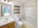 This traditional bathroom has a shower/tub combo, wood shelves, and vanity at 10376 Alice Ct, Fishers, IN 46038