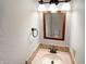 Bright bathroom with a vanity and a brown framed mirror showing the toilet in the background at 10376 Alice Ct, Fishers, IN 46038
