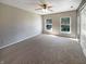 Spacious bedroom with carpet, two windows, a ceiling fan, and closet at 10376 Alice Ct, Fishers, IN 46038