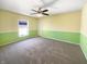Bright bedroom with two-tone walls, carpet flooring, ceiling fan, and natural light at 10376 Alice Ct, Fishers, IN 46038