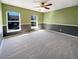 A large bedroom with two windows, two-tone walls, carpet flooring, and a ceiling fan at 10376 Alice Ct, Fishers, IN 46038