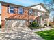 Charming two-story red brick home featuring an attached two-car garage and manicured front lawn at 10376 Alice Ct, Fishers, IN 46038