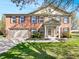 Charming two-story red brick home featuring an attached two-car garage and manicured front lawn at 10376 Alice Ct, Fishers, IN 46038