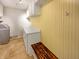 Laundry room with white cabinets, a bench, and a front-loading washing machine at 10376 Alice Ct, Fishers, IN 46038
