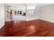 Open-concept living area with hardwood floors leads to carpeted living room with fireplace at 10376 Alice Ct, Fishers, IN 46038