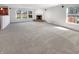 Spacious living room featuring plush carpet, natural light, and a fireplace at 10376 Alice Ct, Fishers, IN 46038