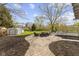 Spacious backyard features a stone patio with outdoor furniture and lots of greenery at 10421 Hillsdale Dr, Carmel, IN 46032