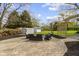 Spacious backyard featuring a paved patio with outdoor seating and a fire pit at 10421 Hillsdale Dr, Carmel, IN 46032