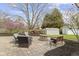 Landscaped backyard featuring stone patio with outdoor seating and a fire pit at 10421 Hillsdale Dr, Carmel, IN 46032