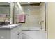 Modern bathroom featuring updated granite vanity top with updated fixtures and tiled shower and tub at 10421 Hillsdale Dr, Carmel, IN 46032