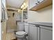 Updated bathroom with tile shower and glass, ample vanity storage, and modern fixtures at 10421 Hillsdale Dr, Carmel, IN 46032