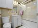 Bright bathroom features a tiled shower and tub with a modern white vanity and sink at 10421 Hillsdale Dr, Carmel, IN 46032