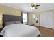 Comfortable bedroom featuring a queen bed, ceiling fan, and natural light at 10421 Hillsdale Dr, Carmel, IN 46032
