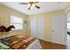 Light-filled bedroom with hardwood floors, ceiling fan, and spacious double door closet at 10421 Hillsdale Dr, Carmel, IN 46032