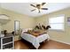 Cozy bedroom with hardwood floors, ceiling fan, and comfortable bed and decor at 10421 Hillsdale Dr, Carmel, IN 46032